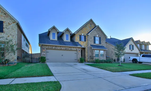 a stone house with potted plants in front of it