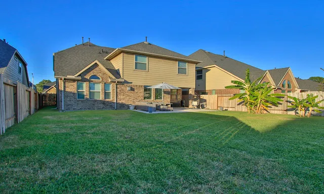 an aerial view of residential houses with outdoor space