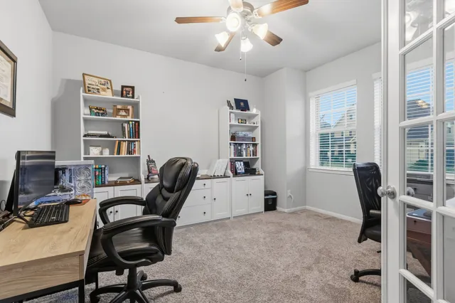 a view of a workspace with furniture and a bookshelf