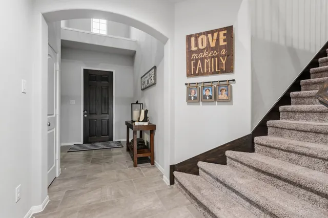 a kitchen with refrigerator and chairs