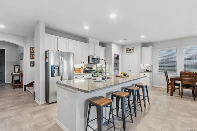 a kitchen with stainless steel appliances granite countertop a sink and stove