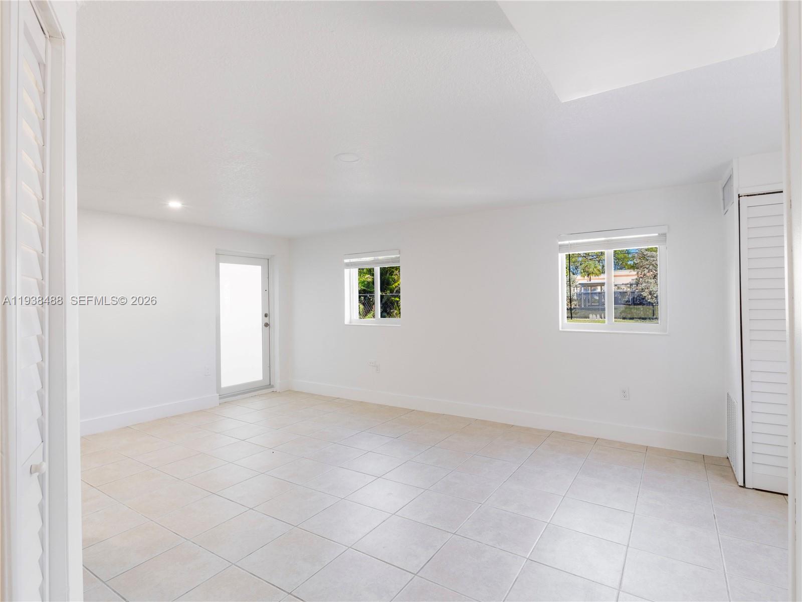 3360 Southwest 6th Street, Unit BOTTOM Miami, FL 33135 - Photo 9 of 17 an empty room with windows