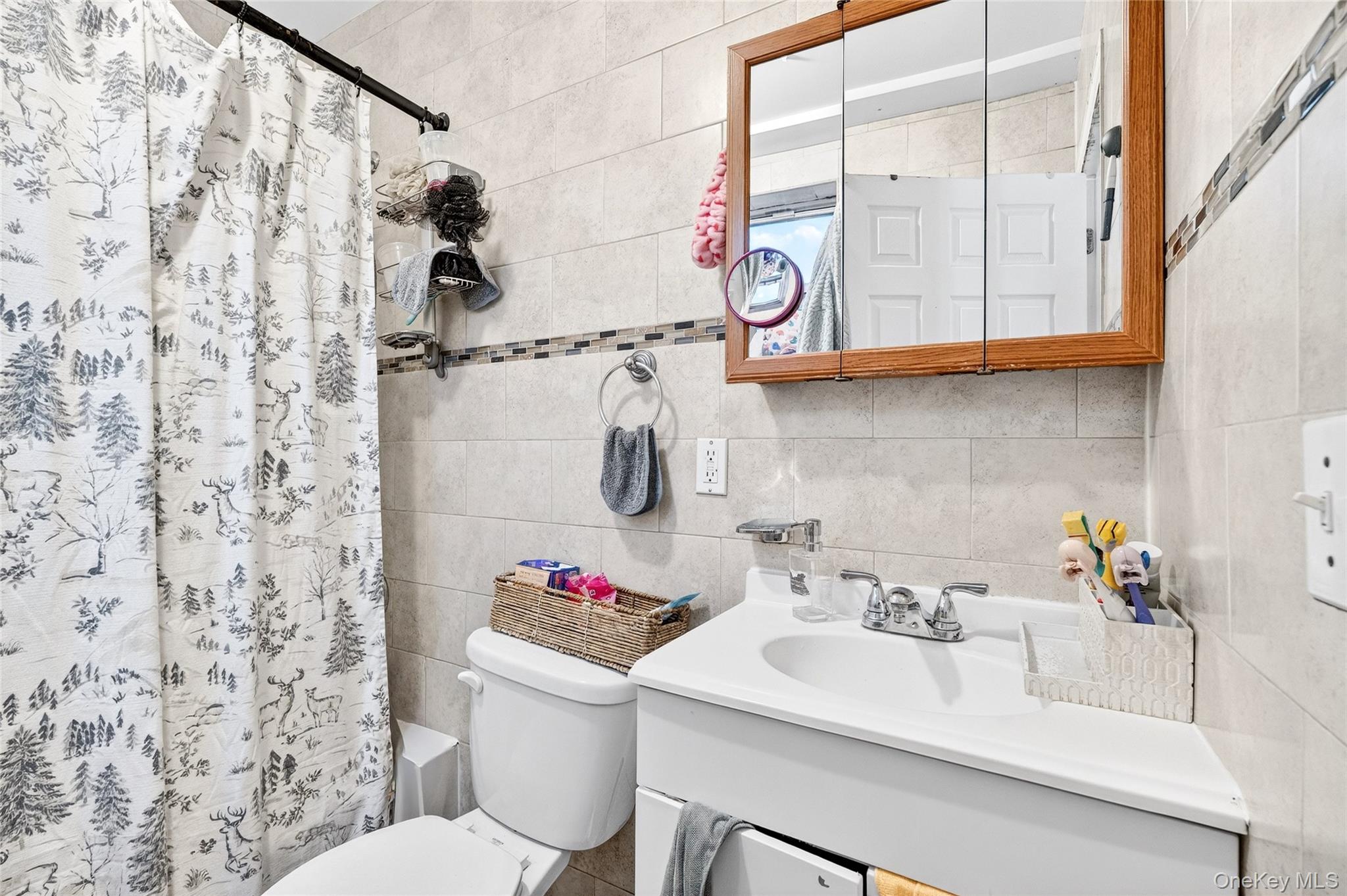 1459 Rosedale Avenue Bronx, NY 10460 - Photo 18 of 37 Full bath featuring vanity, tile walls, shower / tub combo, and decorative backsplash