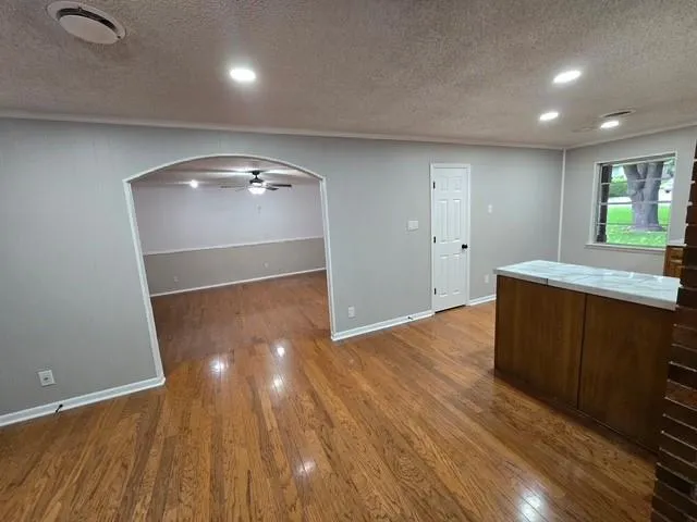 a view of a room with wooden floor