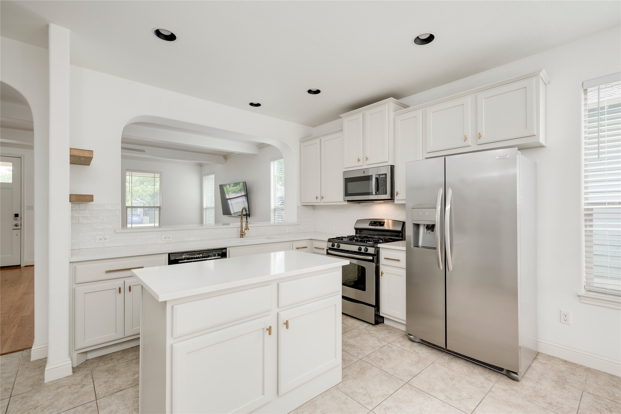 6008 Whipple Way Austin, TX 78745 - Photo 13 of 39 A well-lit kitchen with sleek stainless steel appliances and an inviting central island.