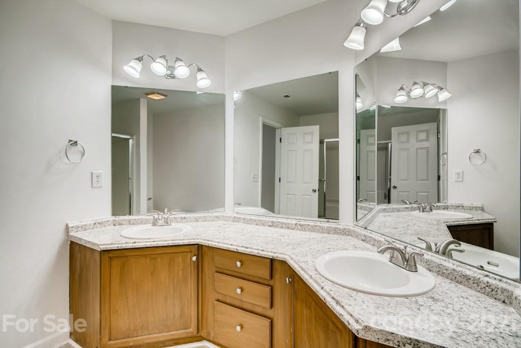 1512 Mineral Springs Road Charlotte, NC 28262 - Photo 12 of 19 a bathroom with a granite countertop sink and a mirror