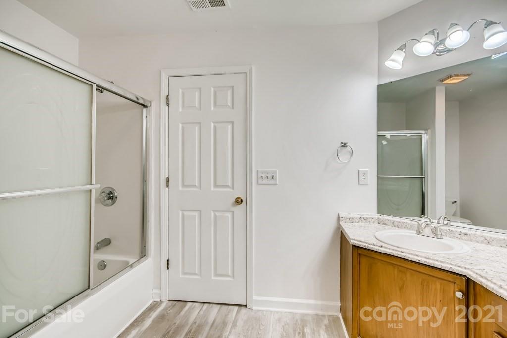 1512 Mineral Springs Road Charlotte, NC 28262 - Photo 13 of 19 a bathroom with a tub a sink and mirror
