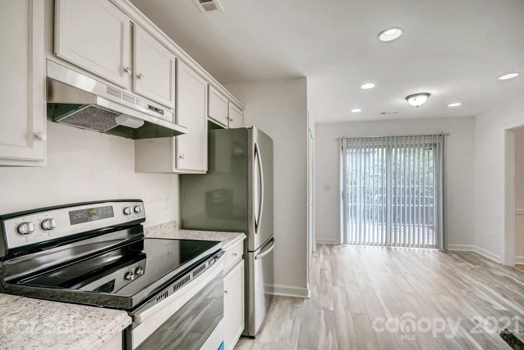 1512 Mineral Springs Road Charlotte, NC 28262 - Photo 5 of 19 a kitchen with stainless steel appliances granite countertop a stove and a refrigerator