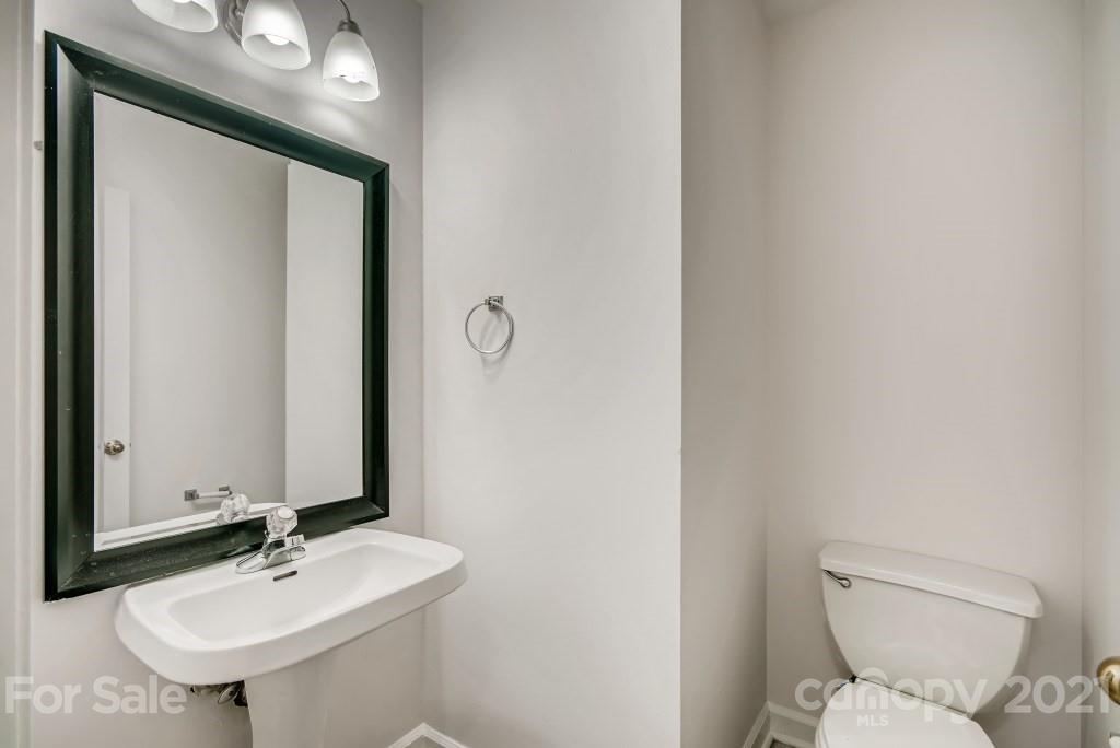 1512 Mineral Springs Road Charlotte, NC 28262 - Photo 9 of 19 a bathroom with a toilet sink and mirror