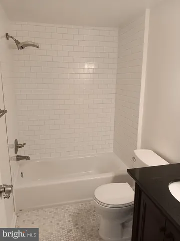 a bathroom with a toilet and a bathtub