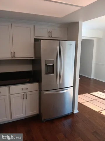 a kitchen with appliances a refrigerator and a sink
