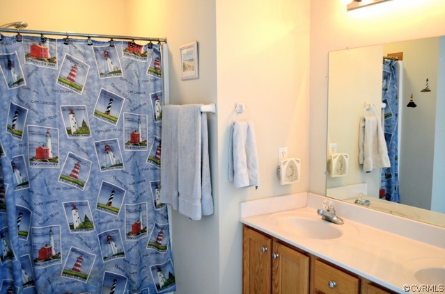 9606 Dunroming Road Chesterfield, VA 23832 - Photo 13 of 19 a bathroom with a sink mirror and shower curtain