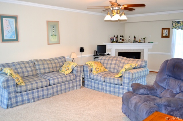 9606 Dunroming Road Chesterfield, VA 23832 - Photo 2 of 19 a living room with furniture a fireplace and chandelier