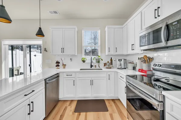 a kitchen with a sink stove and cabinets