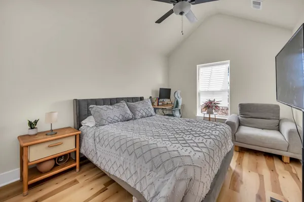 a bedroom with a bed and a couch