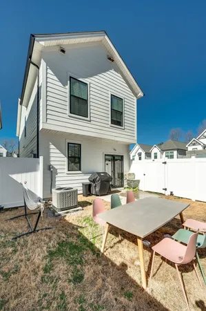 a backyard of a house with table and chairs