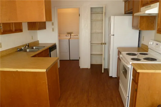 a kitchen that has a sink and a stove