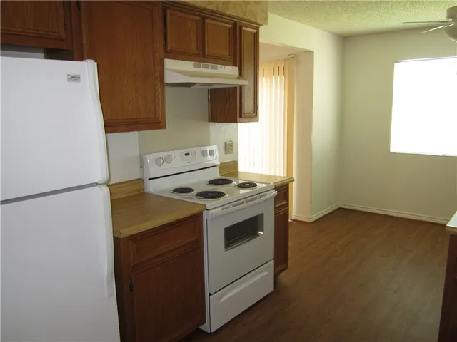 a kitchen with a stove sink and a refrigerator