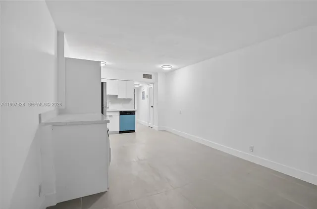 a view of empty room with a fireplace