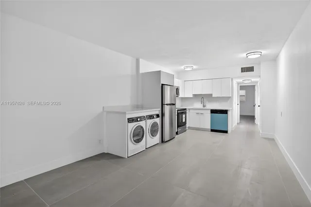 a view of kitchen and refrigerator sink