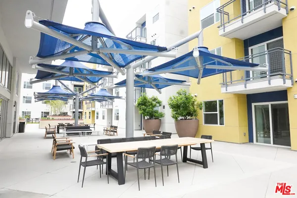 a view of a patio with a table and chairs