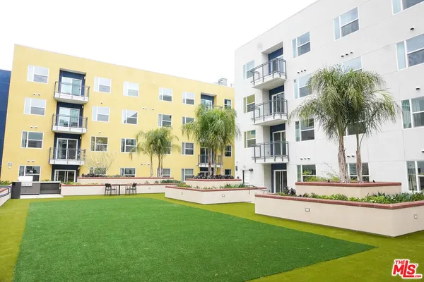 a swimming pool with outdoor seating and yard