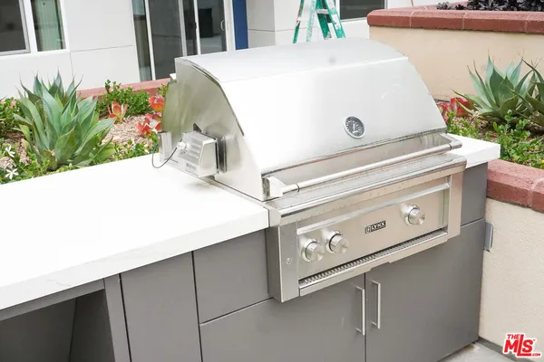 a view of an outdoor dining space with a table and chairs