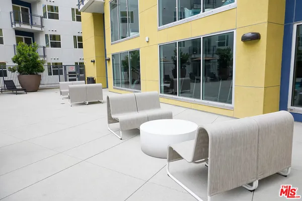 a view of an outdoor space with furniture and windows