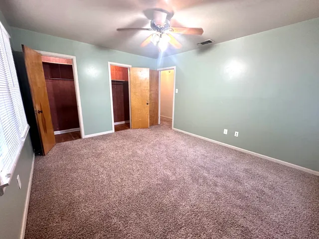 a view of a livingroom with a chandelier fan
