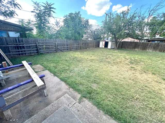 a view of a backyard with sitting area