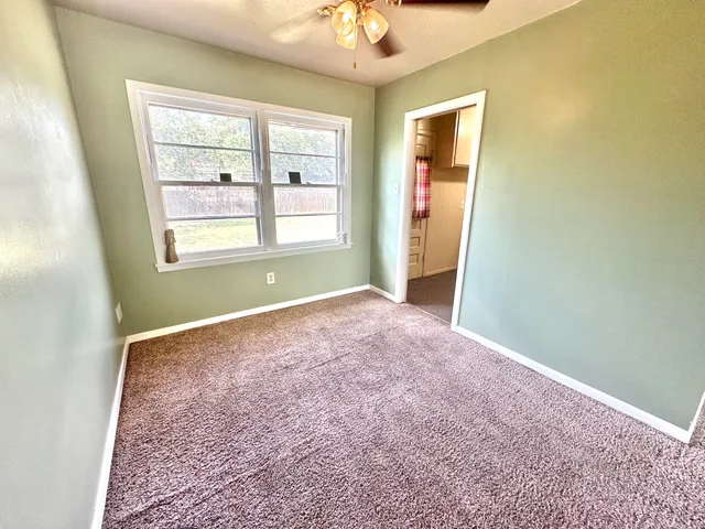 an empty room with windows and closet