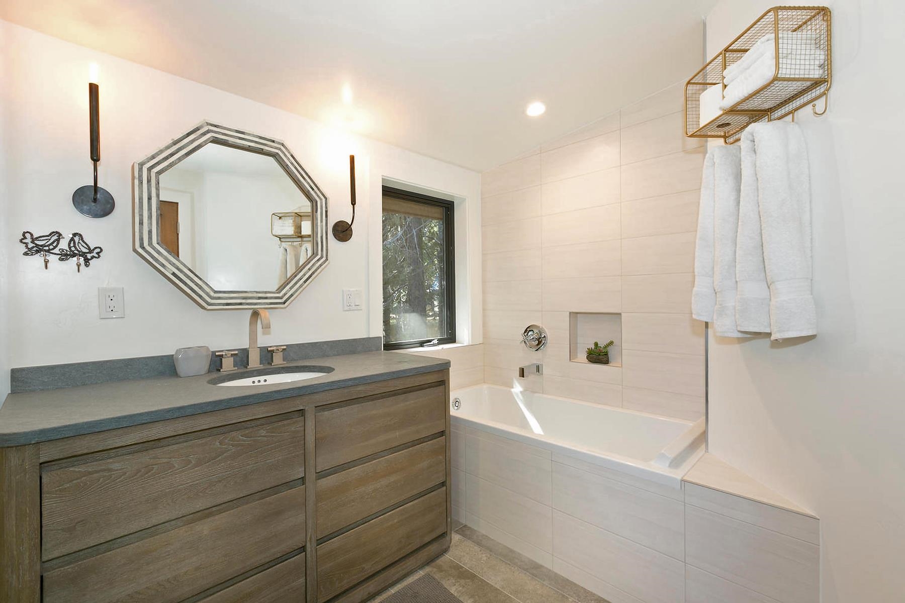 2648 Rustic Lane Homewood, CA 96141 - Photo 16 of 23 a bathroom with a tub sink and mirror