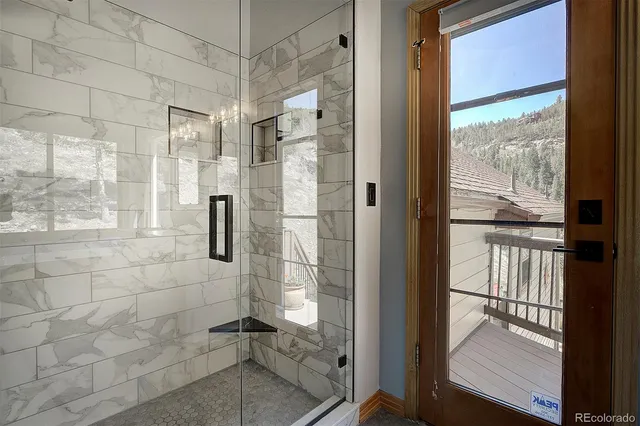 a bathroom with a tub a sink and mirror