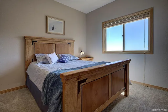 a balcony with wooden floor table and chairs