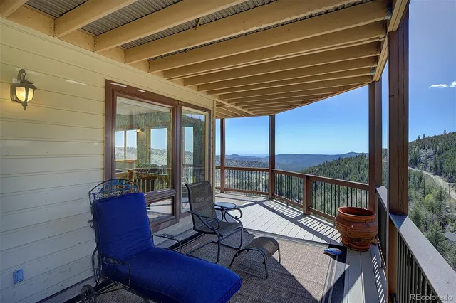 a view of sitting area with furniture on wooden deck