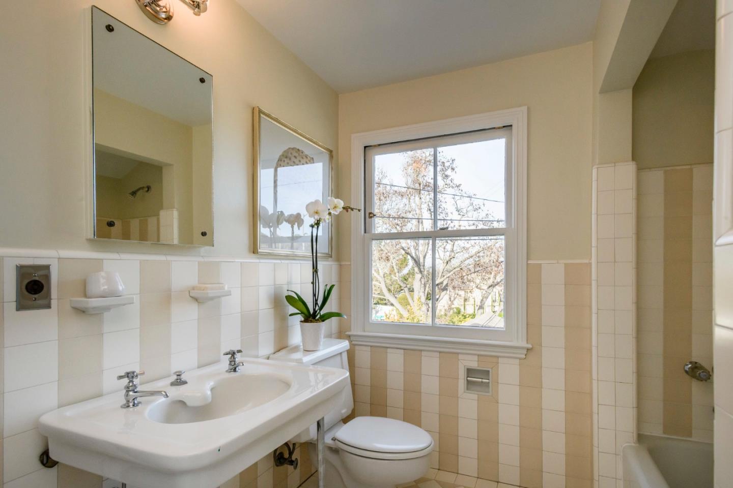 604 Parrott Drive San Mateo, CA 94402 - Photo 16 of 35 a bathroom with a sink a toilet and a mirror