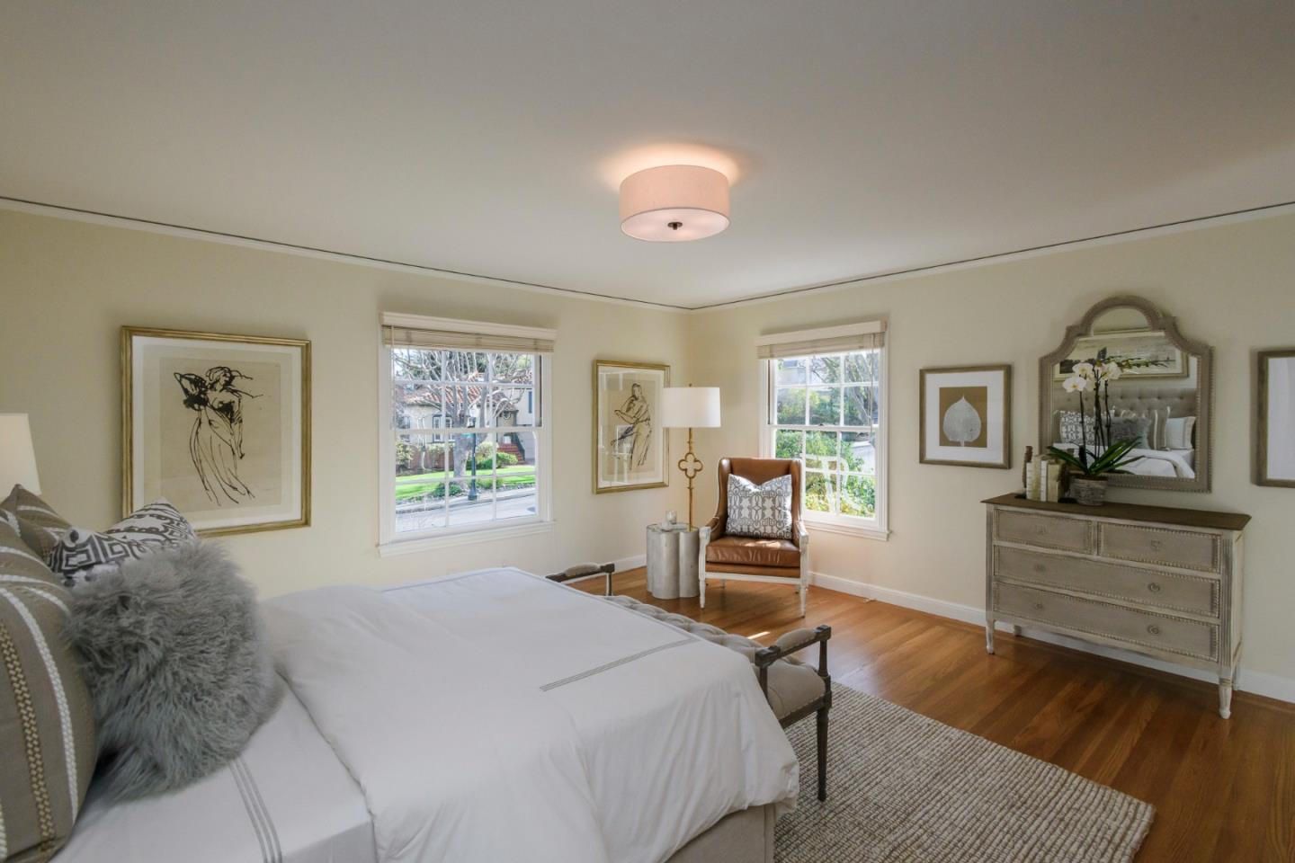 604 Parrott Drive San Mateo, CA 94402 - Photo 19 of 35 a bedroom with a large bed and wooden floor