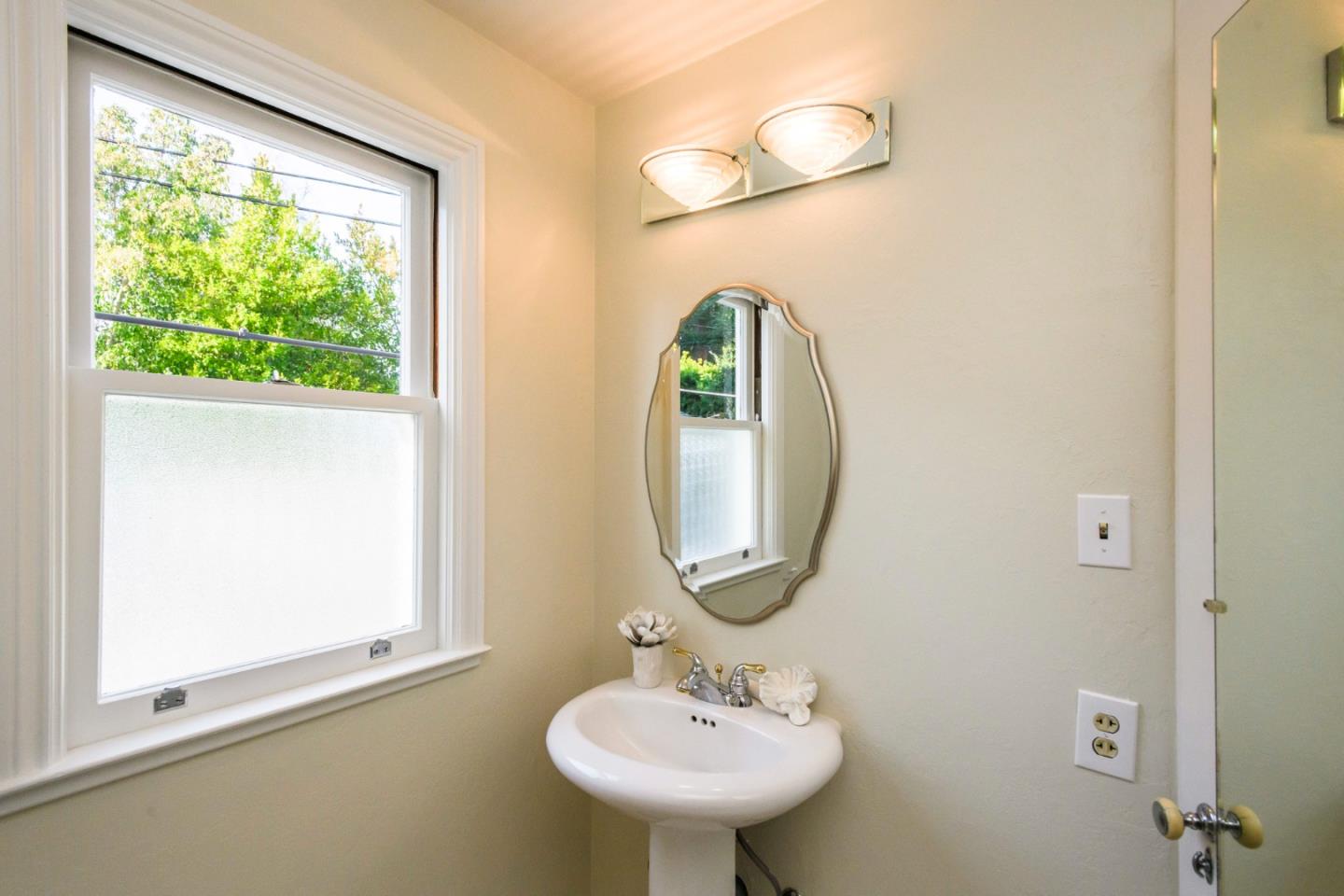 604 Parrott Drive San Mateo, CA 94402 - Photo 25 of 35 a bathroom with a sink and a mirror