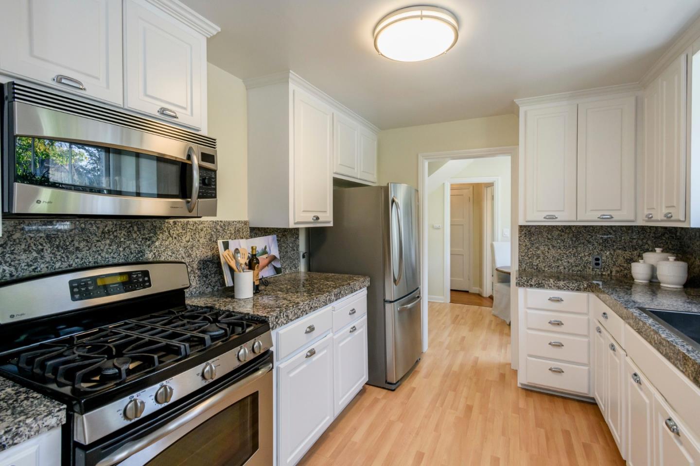 604 Parrott Drive San Mateo, CA 94402 - Photo 9 of 35 a kitchen with stainless steel appliances granite countertop a stove a sink and a refrigerator