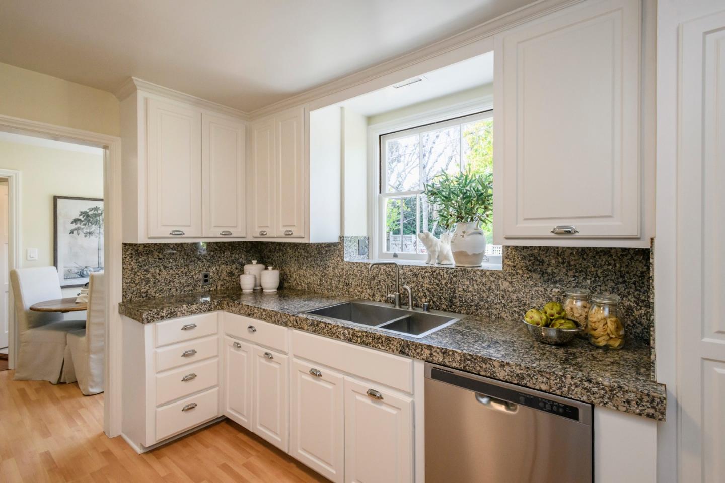 604 Parrott Drive San Mateo, CA 94402 - Photo 10 of 35 a kitchen with granite countertop white cabinets and white appliances
