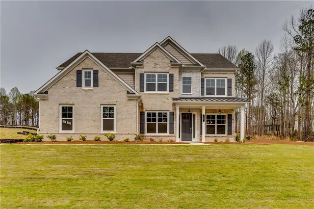 a front view of a house with a yard