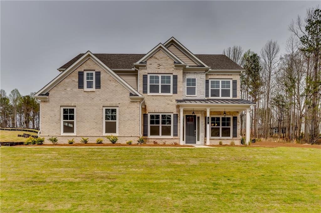 a front view of a house with a yard