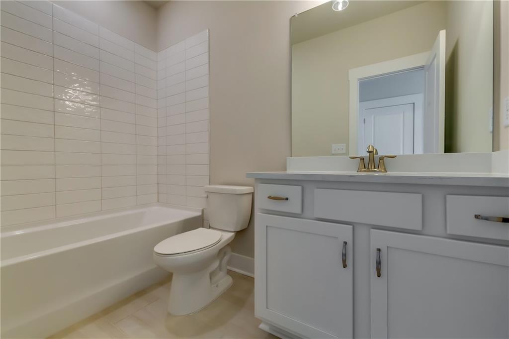 12 Overview Court Hoschton, GA 30548 - Photo 12 of 18 a bathroom with a sink toilet vanity and tub