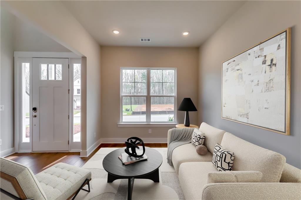 12 Overview Court Hoschton, GA 30548 - Photo 4 of 18 a living room with furniture and window