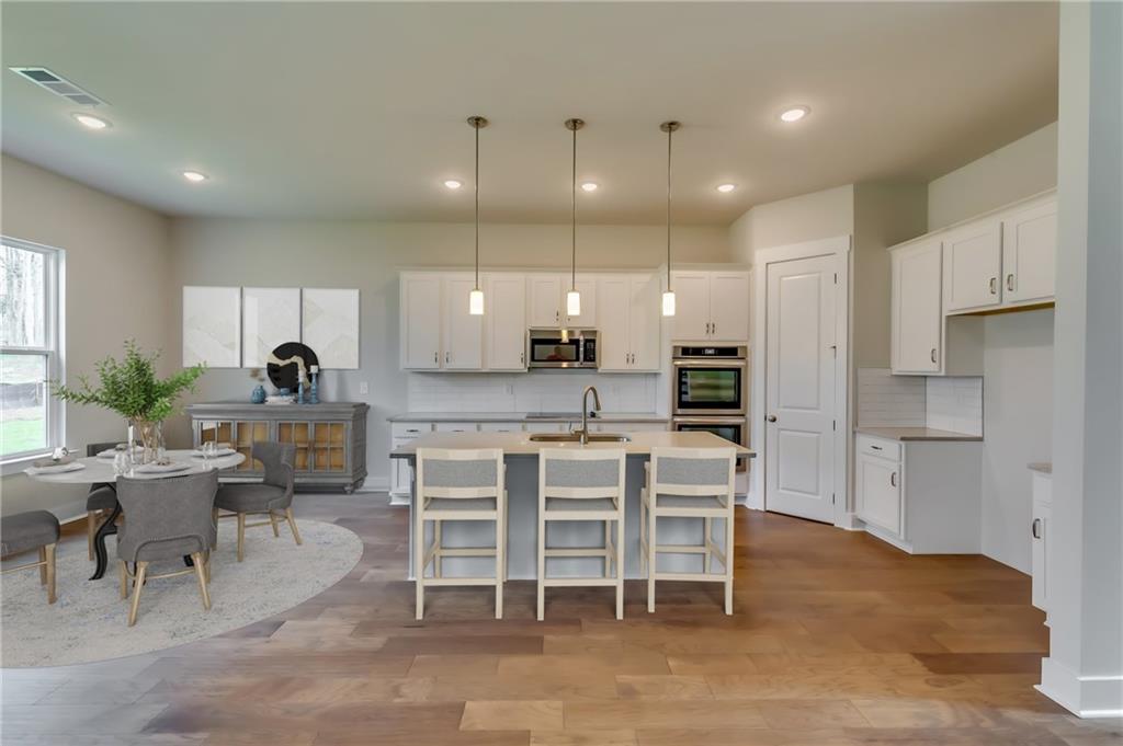 12 Overview Court Hoschton, GA 30548 - Photo 5 of 18 a large kitchen with a table and chairs