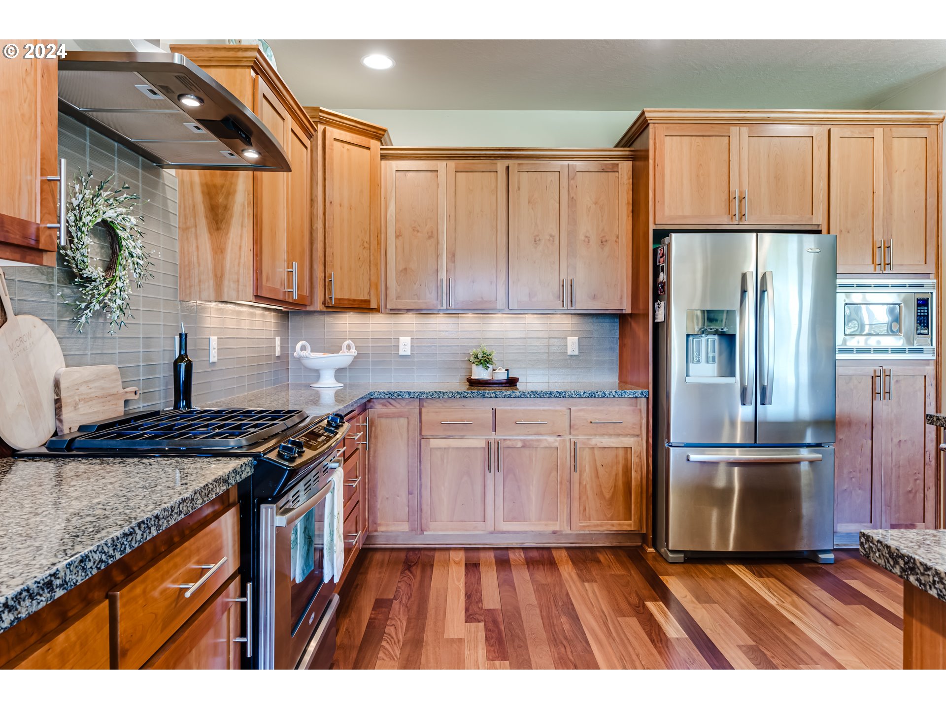 6234 Graystone Loop Springfield, OR 97478 - Photo 19 of 43 a kitchen with granite countertop a refrigerator stove top oven and sink