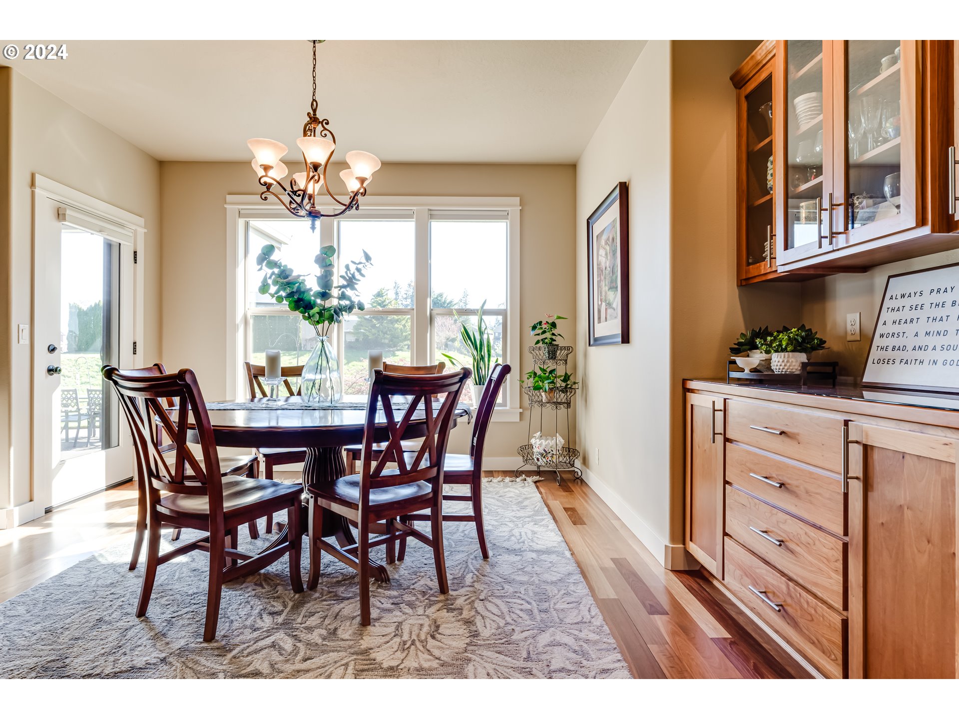 6234 Graystone Loop Springfield, OR 97478 - Photo 22 of 43 a view of a dining room with furniture a chandelier and wooden floor