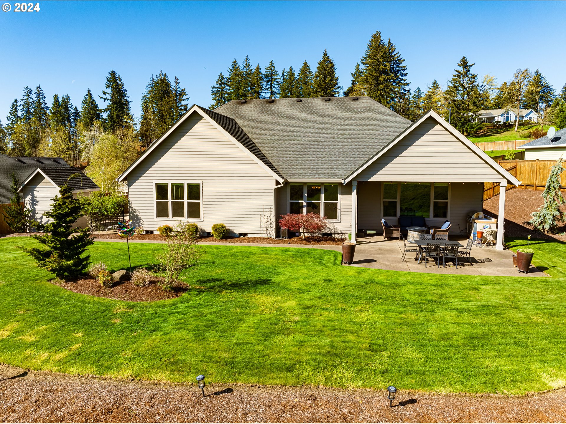 6234 Graystone Loop Springfield, OR 97478 - Photo 41 of 43 a view of a house with backyard porch and sitting area