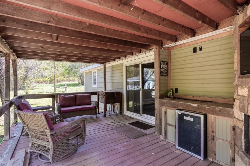 1701 Central Road Weatherford, TX 76088 - Photo 30 of 40 Wooden deck with wine cooler and outdoor seating
