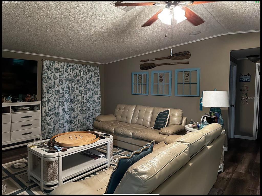 90 Whipporwill Court Ellenton, FL 34222 - Photo 11 of 34 a living room with furniture a flat screen tv and a lamp